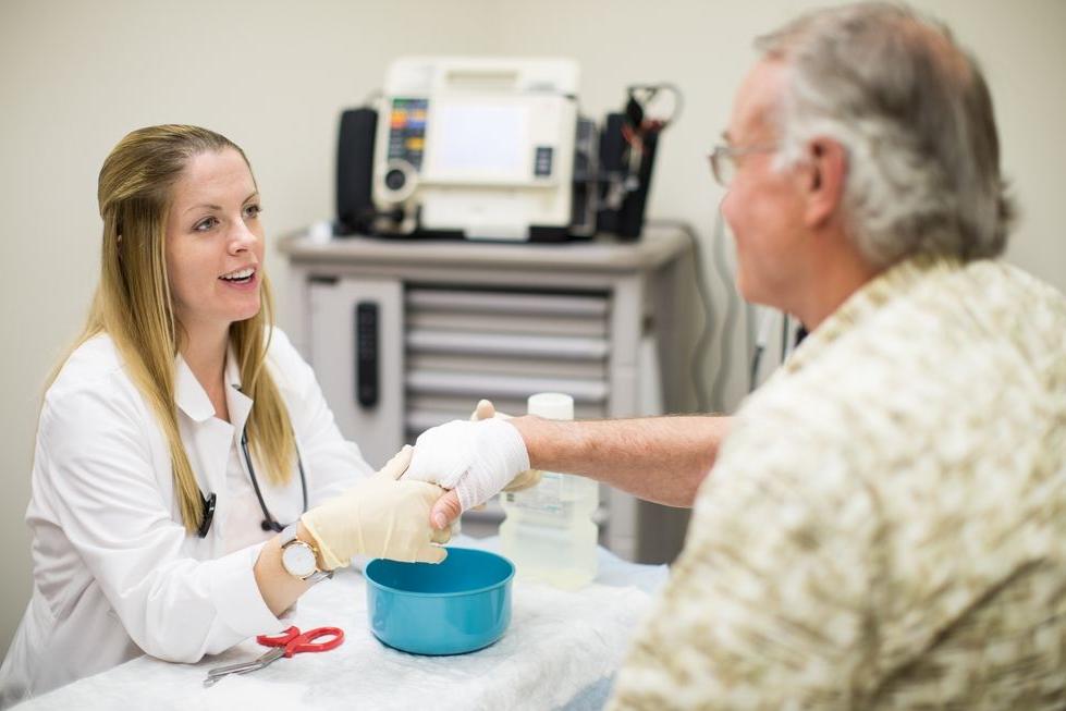 nursing student treating patient